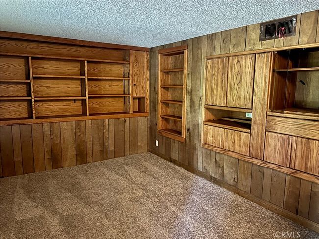 Den located on bottom entry level. Built in cabinets. | Image 8