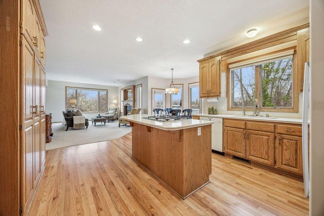 Kitchen has island, and corion countertops | Image 11