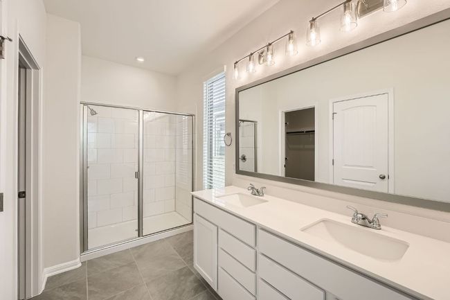 Full bathroom featuring tile patterned flooring, a stall shower, and a sink | Image 18