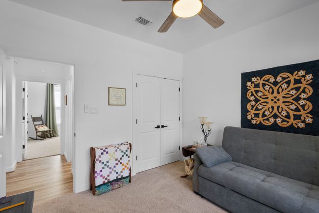 Living room with visible vents, a ceiling fan, and carpet | Image 20