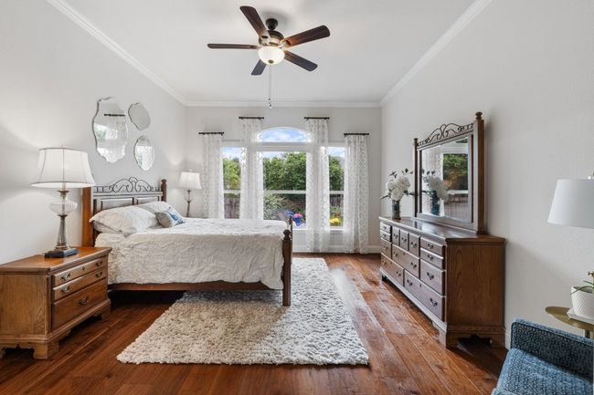 Primary bedroom has lots of natural light, view of pool, and motorized shades for sleeping comfort | Image 20