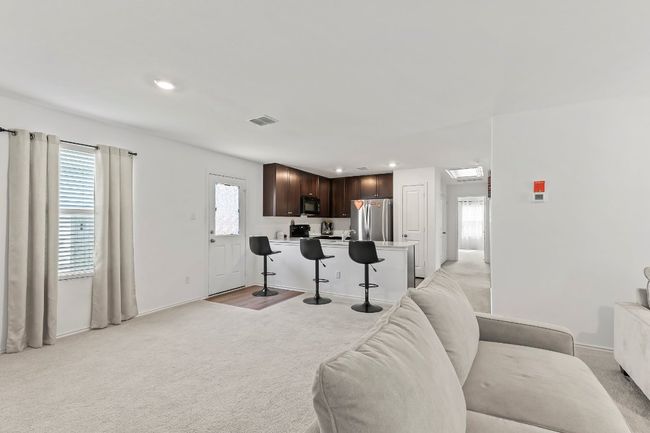 Living area with recessed lighting and light colored carpet | Image 11