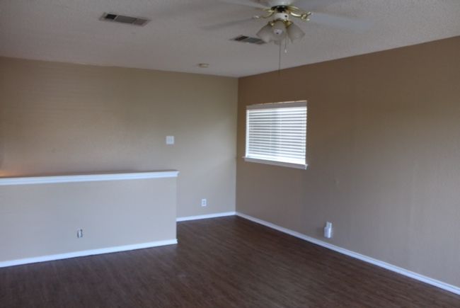 Empty room featuring ceiling fan, dark wood-style floors, and baseboards | Image 8
