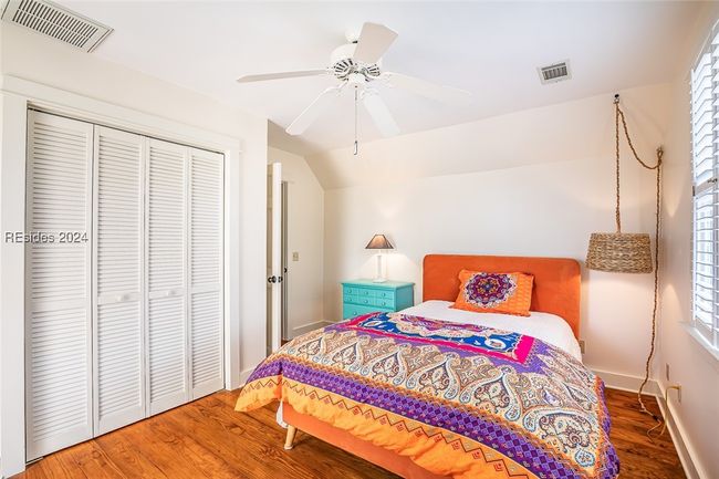 Bedroom featuring lofted ceiling, ceiling fan, a closet, and dark hardwood / wood-style flooring | Image 41