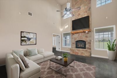 The two story stone fireplace is just one of the beautiful features of the main living space. Virtually Staged. | Image 1