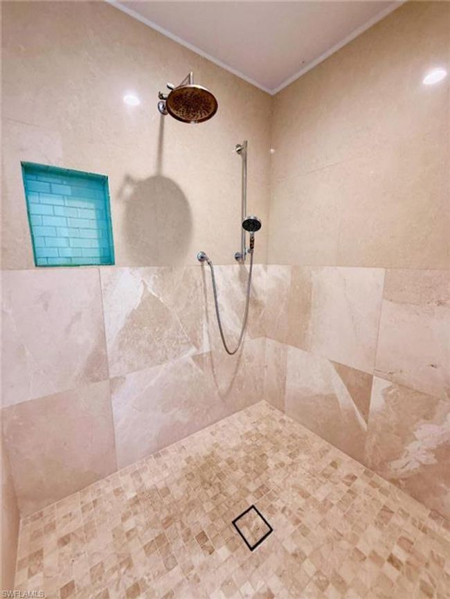 Bathroom featuring tiled shower and ornamental molding | Image 19