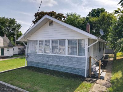 View of front of home featuring central AC unit and a front lawn | Image 2