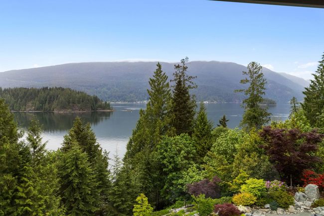 View of mountain backdrop featuring a heavily wooded area and a large body of water | Image 34
