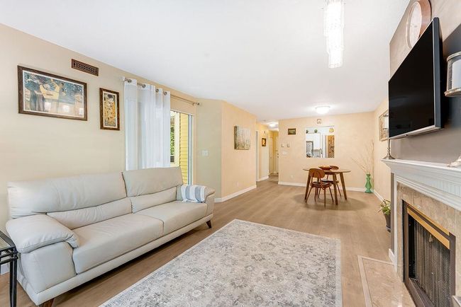 Living area with light wood-style floors, baseboards, and a high end fireplace | Image 23