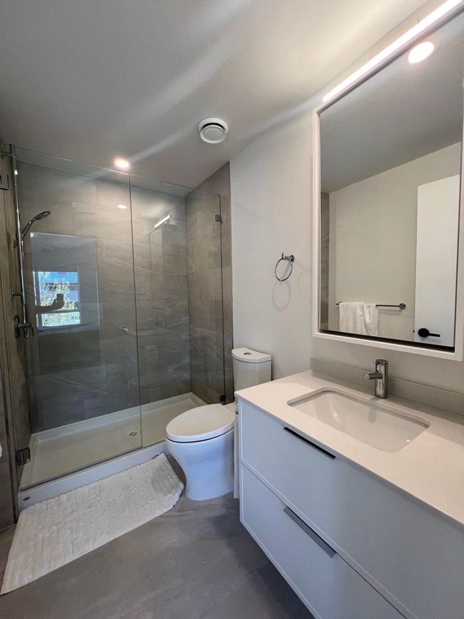 Full bath featuring recessed lighting, a shower stall, toilet, and vanity | Image 11
