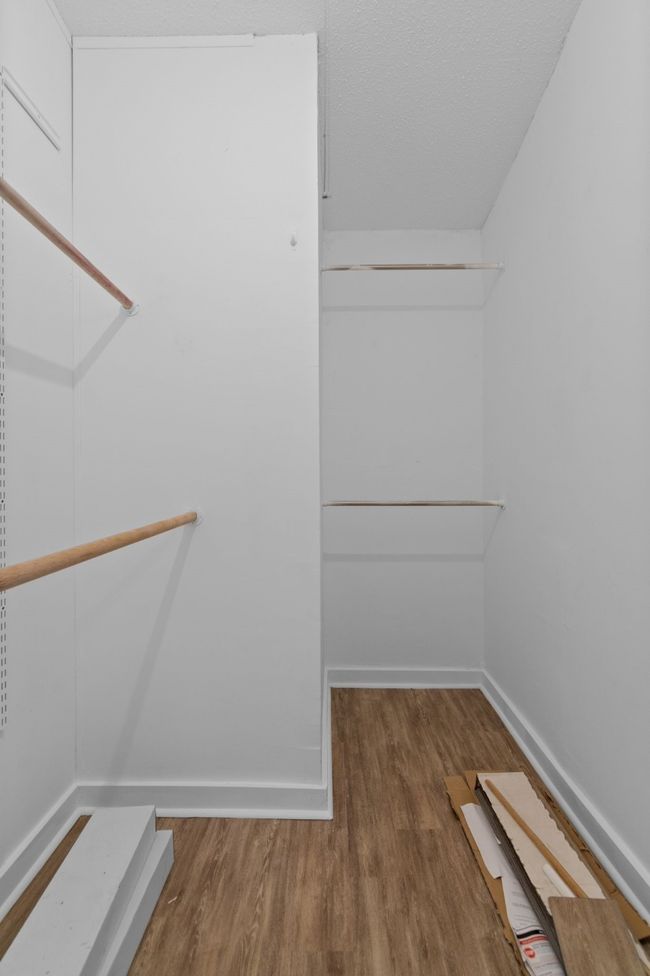 Spacious closet with wood finished floors | Image 25