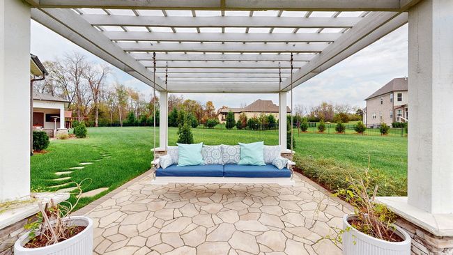 Charming custom built pergola with a swing that sits against a soothing waterfall backdrop.... | Image 60