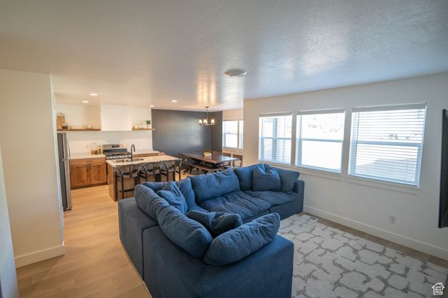 Light & Bright living room with lots of windows, stunning LVP wood flooring, and recessed lighting. | Image 6