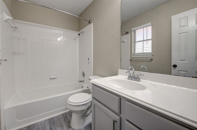 Bathroom featuring wood finished floors, vanity, and shower / tub combination | Image 19