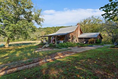 The main house features a large covered front porch, and two separate screen porches. The one in the back is a private screened in patio off of the Master Suite. | Image 3