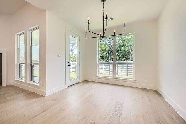 Unfurnished dining area featuring a chandelier, light wood-style floors, and​​‌​​​​‌​​‌‌​‌‌​​​‌‌​​‌‌​‌​​​​​‌ baseboards | Image 9