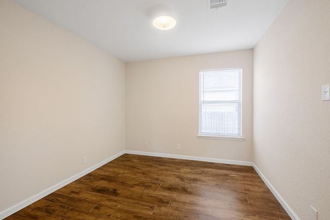 Empty room with dark wood-style floors and baseboards | Image 17