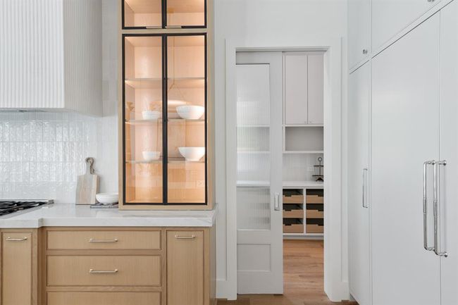 Custom-designed pocket doors offer a seamless transition between the butler’s pantry and the main living and dining spaces—allowing for both elegant separation and uninterrupted flow. Their sleek, architectural profile adds a refined detail while maximizing function and flexibility in the heart of the home | Image 14