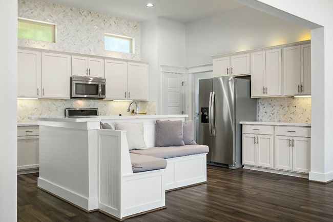 Kitchen with tasteful backsplash, appliances with stainless steel finishes, light countertops, and a towering ceiling | Image 14