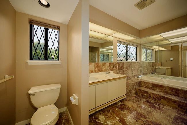 Bathroom with plenty of natural light, marble finish flooring, a bath, and double vanity | Image 19