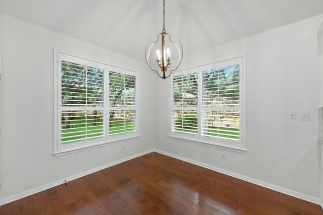 New chandelier, simple plantation shutters and windows that overlook a beautiful shaded backyard haven. | Image 16