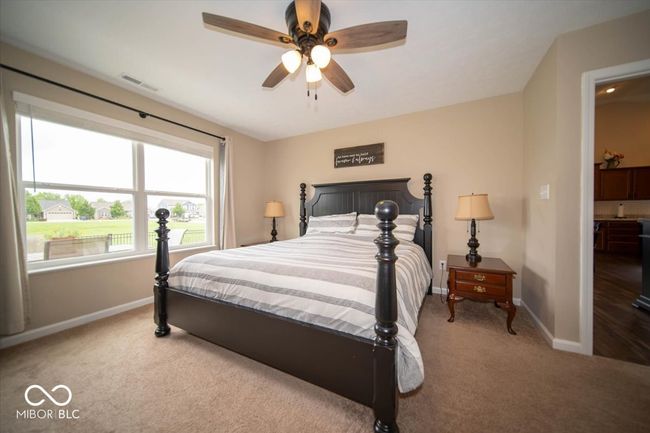 bedroom featuring carpet flooring, baseboards, and ceiling fan | Image 19