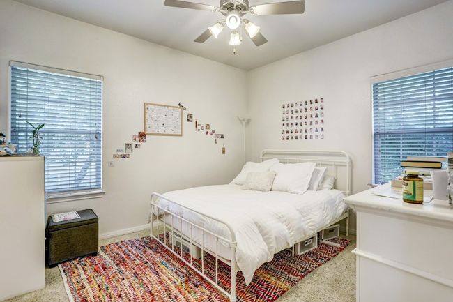 Carpeted bedroom with a ceiling fan | Image 16
