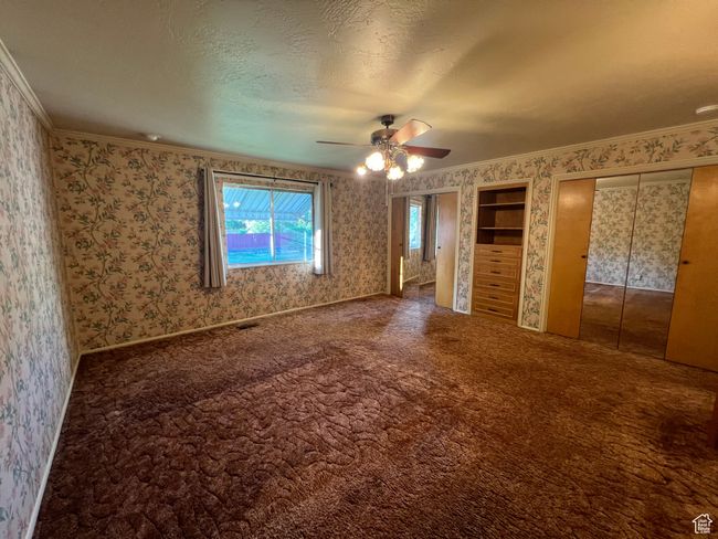 Main larger bedroom suite, 2 closest and built ins in the bedroom and the hallway has more storage space, stackable laundry and separate entrance from outside. | Image 15