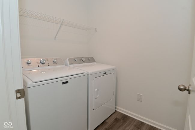 laundry area featuring a washing machine and clothes dryer. | Image 51