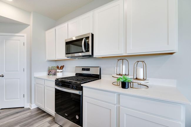 Amazing stainless steel Whirlpool gas stove and microwave that vents outside included in every home. Previously built model home, finishes, selections, and colors to vary from future built home. | Image 9