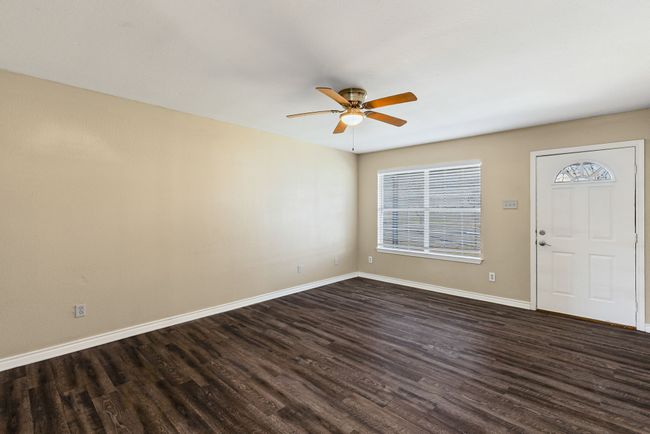 Foyer featuring dark wood-style floors, ceiling fan, and baseboards | Image 6