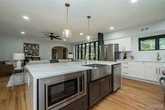 ~8ft island features a large farmhouse style sink, built in microwave and dishwasher. | Image 12