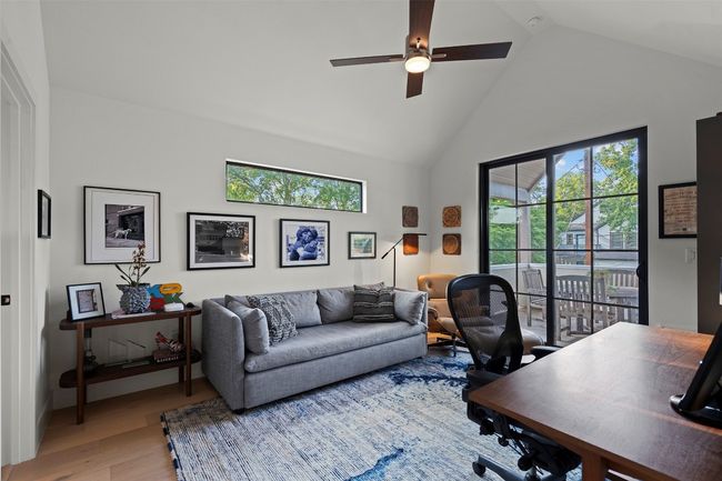 Home office featuring ceiling fan, light wood finished floors, and high vaulted ceiling | Image 32