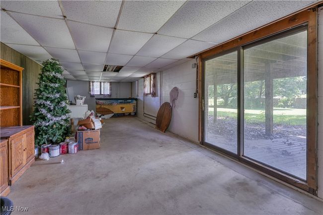 basement living area with bar and walk out | Image 33