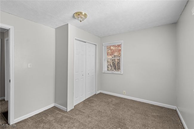 Unfurnished bedroom featuring baseboards, a closet, carpet flooring, and a textured ceiling | Image 17
