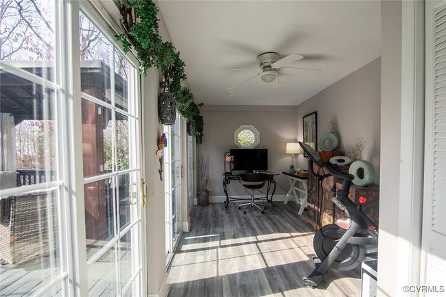 Home office with baseboards, ceiling fan, and wood finished floors | Image 15