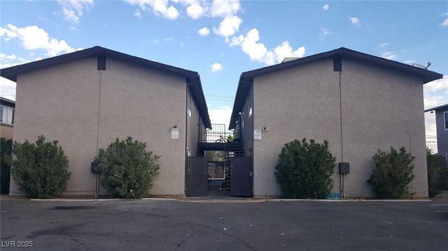View of home's exterior featuring stucco siding and a gate | Image 11
