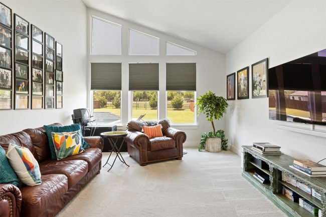 Carpeted living room with high vaulted ceiling and baseboards | Image 28