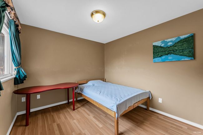 Bedroom with baseboards and wood finished floors | Image 15