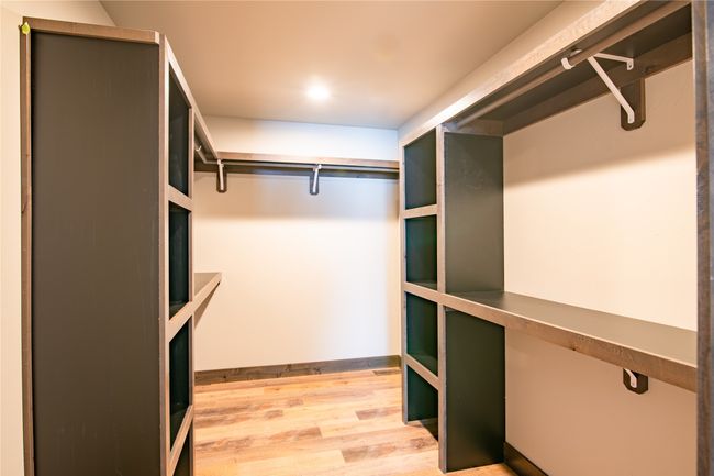 Walk in closet featuring hardwood / wood-style floors | Image 20