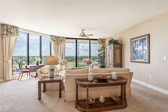 Living room featuring light carpet, ceiling fan, and a wealth of natural light | Image 14