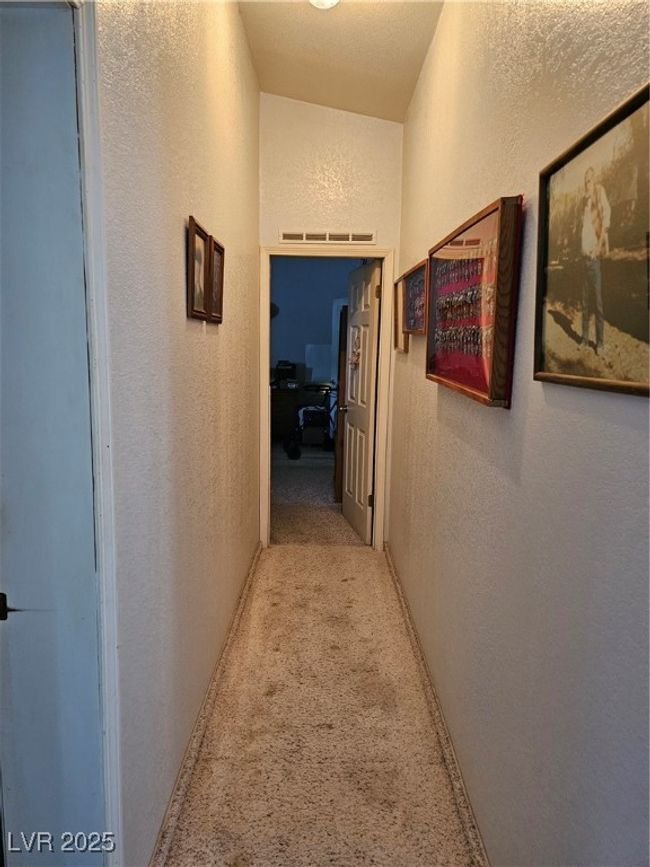 Hall with carpet flooring and a textured wall | Image 13