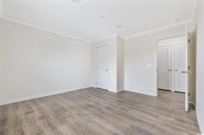 Unfurnished room featuring ornamental molding, light wood-style floors, and a smoke detector | Image 22