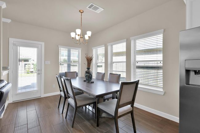 Surrounded by windows, this dining room provides the perfect setting for quick daily meals or lavish dinner party gatherings. | Image 10