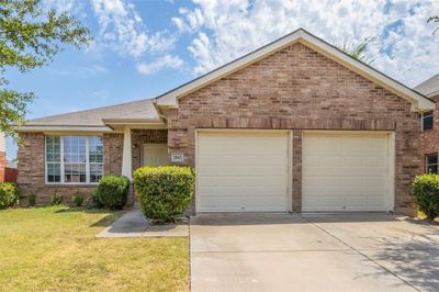 View of front of house featuring a garage and a front lawn | Image 1