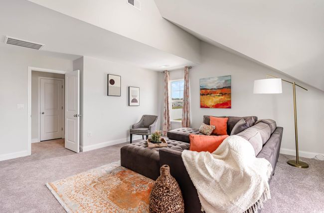Living room featuring light colored carpet and lofted ceiling | Image 22