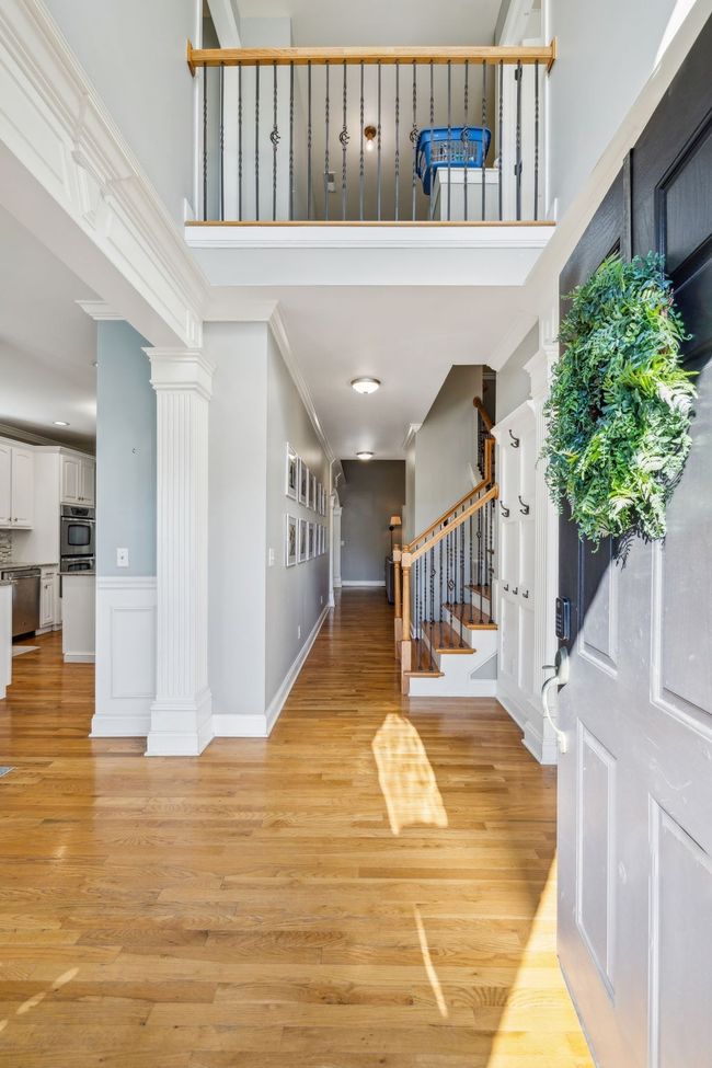 This bright two story foyer welcomes you and your guests into the home. | Image 6