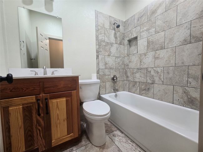 Bathroom featuring vanity and shower / bath combination | Image 18