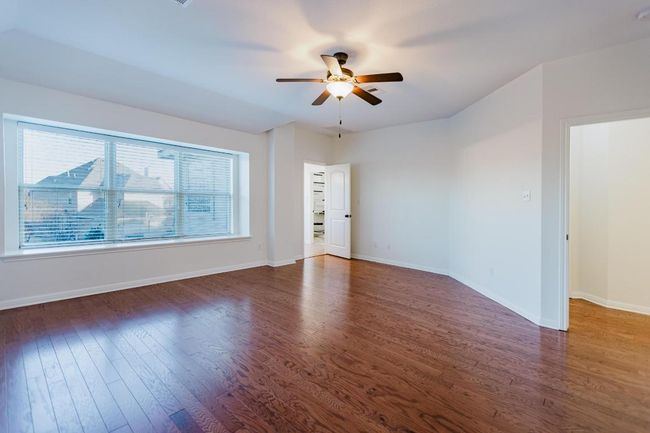 Primary Bedroom, featuring baseboards, wood finished floors, and ceiling fan | Image 27
