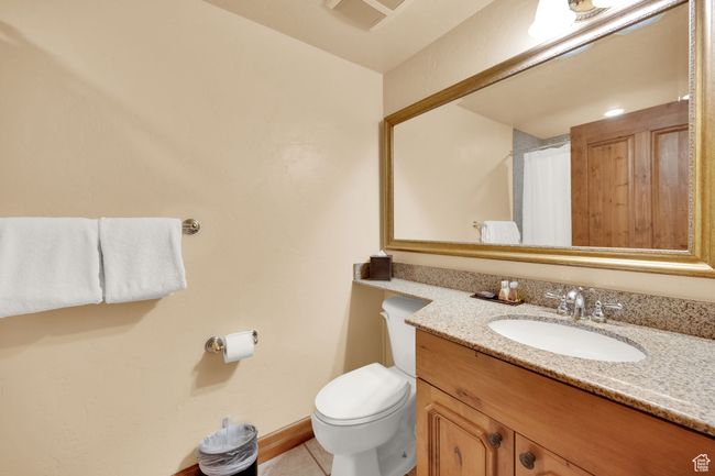 Bathroom with tile patterned floors, visible vents, toilet, and vanity | Image 29